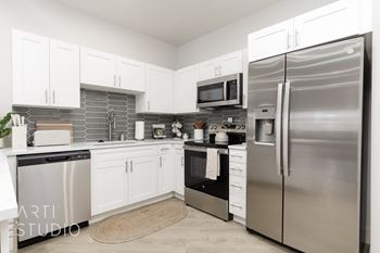 Kitchen with a refrigerator, dishwasher, and microwave